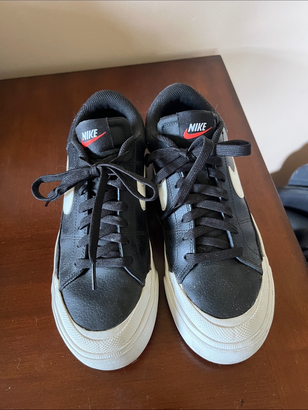 Nike Women’s Black Sneakers with White Swoosh and Red Tongue Logo